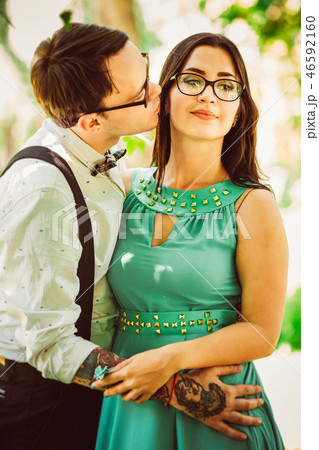 Beautiful young couple on the park background Beautiful young couple on the park background 46592160