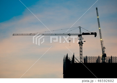 Crane and building construction site at sunrise  46592602