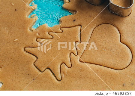 metal molds on dough men tree a blue background metal molds on dough men tree a blue background 46592857