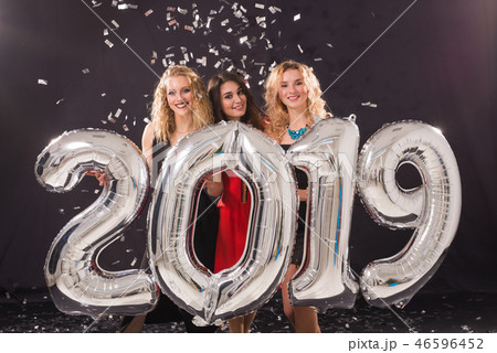 Party, people and new year holidays concept - cheerful young women celebrating new years eve 2019 Party, people and new year holidays concept - cheerful young women celebrating new years eve 2019 46596452