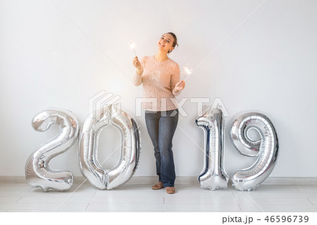 Party, people and new year holidays concept - woman celebrating new years eve 2019 with and 46596739