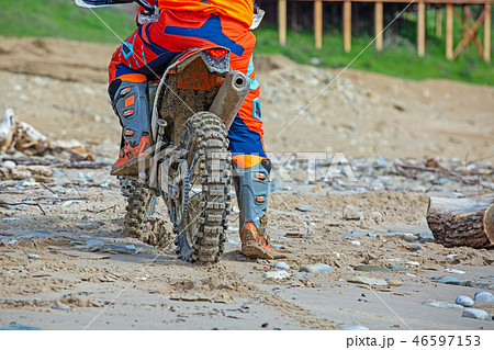 Professional Motocross Motorcycle Rider Drives Over the Road Track. Professional Motocross Motorcycle Rider Drives Over the Road Track. 46597153