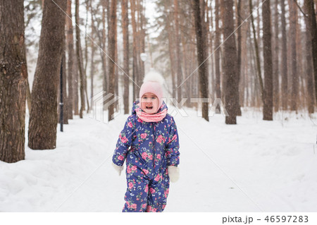 Children and nature concept - Adorable baby girl walking in winter park 46597283