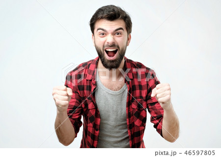 Portrait of happy spanish man with fists up celebrating his victory 46597805