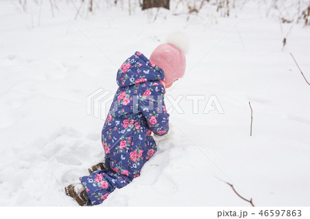 Children, winter and nature concept - Close up of adorable kid playing with snow in the park Children, winter and nature concept - Close up of adorable kid playing with snow in the park 46597863