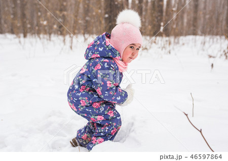 Childhood and children concept - baby girl walk in the winter outdoors 46597864