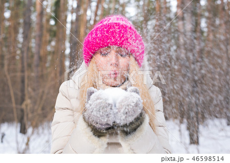 Christmas Girl. Winter young woman blowing snow in winter nature Christmas Girl. Winter young woman blowing snow in winter nature 46598514