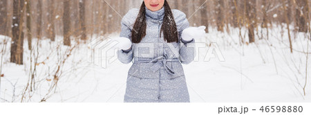 Season, leisure and people concept - close up of woman is happy and throwing snow in the winter Season, leisure and people concept - close up of woman is happy and throwing snow in the winter 46598880