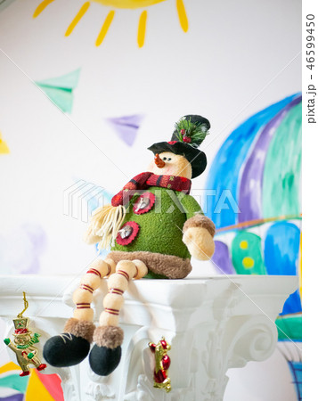cute fabric handmade xmas toy sitting on column 46599450