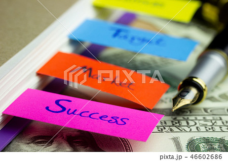 Notebook and multicolour bookmark with banknote. 46602686