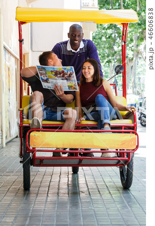Couple riding around city on rickshaw 46606838