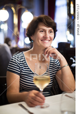 Woman with wine at restaurant Woman with wine at restaurant 46607117