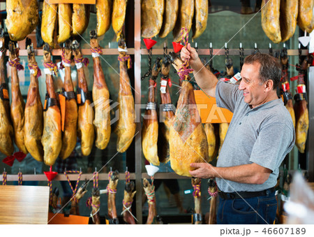 Customer buying iberico or serrano jamon leg 46607189