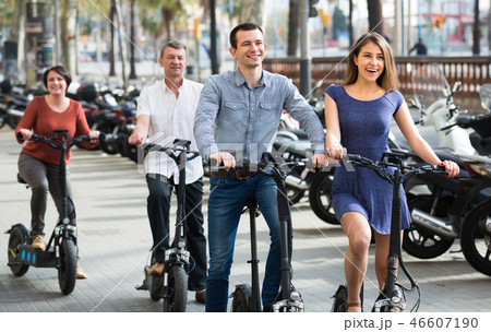 Adults traveling through city by bicycles. Adults traveling through city by bicycles. 46607190