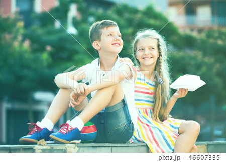Two kids sitting together outdoor. Two kids sitting together outdoor. 46607335