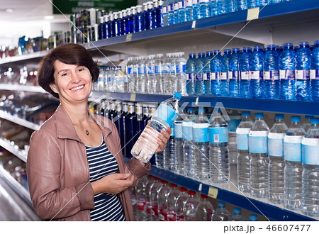 woman selecting water at the store. woman selecting water at the store. 46607477