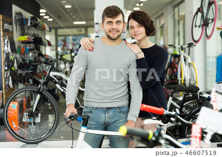 couple standing with bicycle couple standing with bicycle 46607519