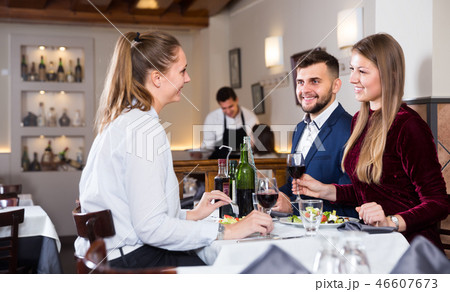 Group of happy friends enjoying evening meal at restaurant 46607673