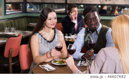 Couple with female friend in restaurant Couple with female friend in restaurant 46607682