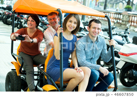 Family of four sitting in grand tour electric Family of four sitting in grand tour electric 46607850