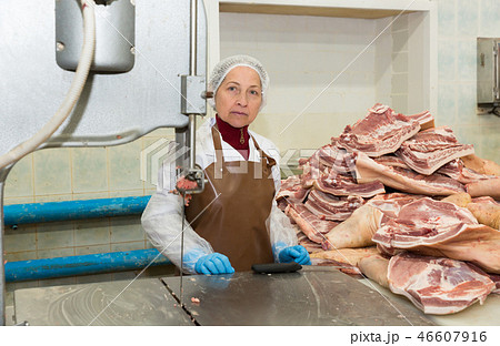 Woman cutting meat on machine Woman cutting meat on machine 46607916