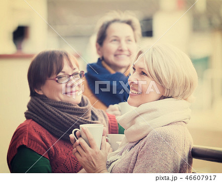 Senior women drinking tea at balcony Senior women drinking tea at balcony 46607917