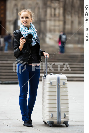 Young female traveller with camera Young female traveller with camera 46608035