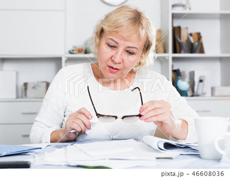 Woman engaged in home accounting Woman engaged in home accounting 46608036