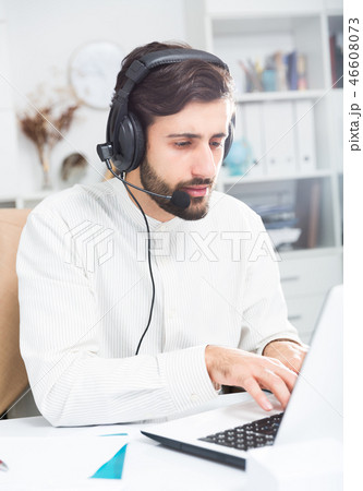 Man with earphones working at office 46608073