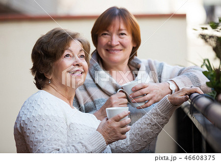 Women in pullovers on terrace Women in pullovers on terrace 46608375