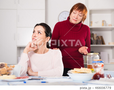 Mature female talking with young sad daughter Mature female talking with young sad daughter 46608779
