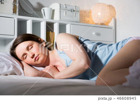 Portrait of relaxed girl in pyjama sleeping in bed in home 46608945