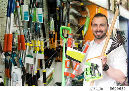Man with gardening tools in the shop Man with gardening tools in the shop 46609682
