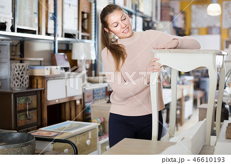 Girl customer choosing bedside in the furniture store Girl customer choosing bedside in the furniture store 46610193