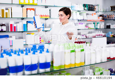 Customer woman is browsing rows of body care products Customer woman is browsing rows of body care products 46610194