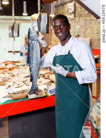 Salesman offering fresh fish Salesman offering fresh fish 46610478
