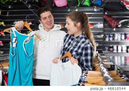 Young tennis couple is looking on tennis T-shirt Young tennis couple is looking on tennis T-shirt 46610544