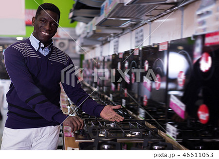Happy man selecting new cooking top in store Happy man selecting new cooking top in store 46611053