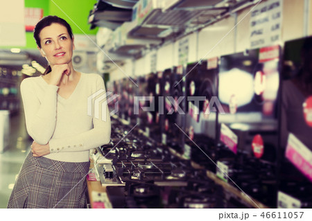 Woman selecting new cooking top Woman selecting new cooking top 46611057
