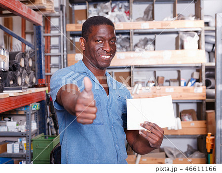 Satisfied African American man recommending ceramic tile in building material store Satisfied African American man recommending ceramic tile in building material store 46611166