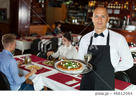 Waiter with tray in restaurant Waiter with tray in restaurant 46612064