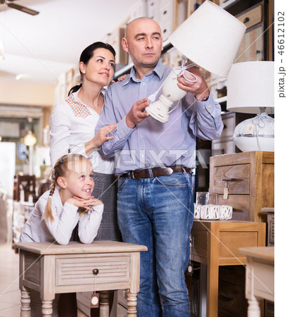 Family choosing lamp in store Family choosing lamp in store 46612102