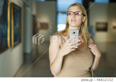Woman taking photo in museum 46612132