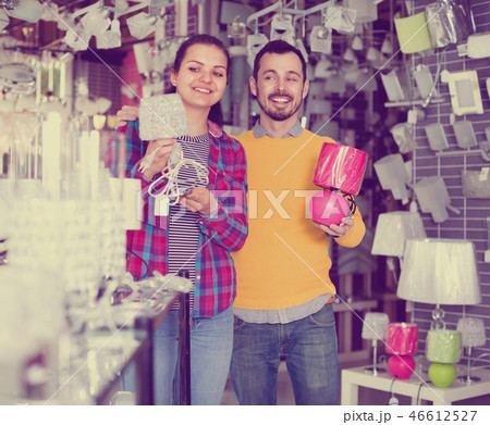 Smiling young man and girl in lighter shop choose night light 46612527