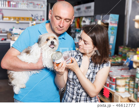 couple with small dog choosing preserves couple with small dog choosing preserves 46612777
