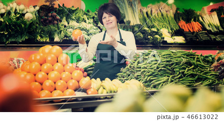 Portrait of adult female selling fruits and vegetables Portrait of adult female selling fruits and vegetables 46613022