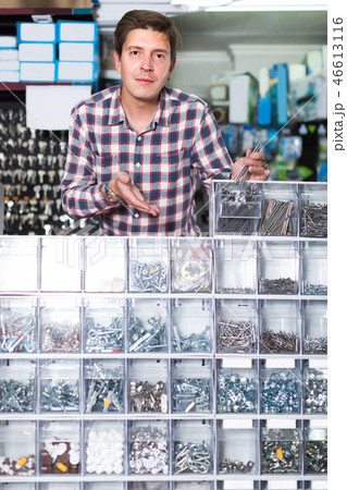 Employee in hardware store is trading goods for construction 46613116