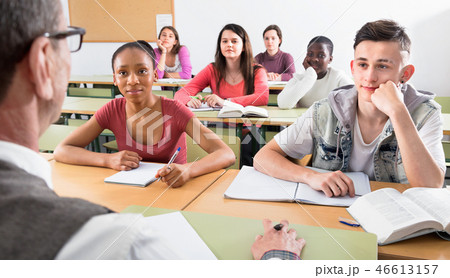 Enthusiastic girls and boys taking the notes while 46613157