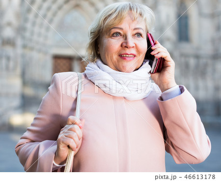 adult woman talking on mobile phone adult woman talking on mobile phone 46613178