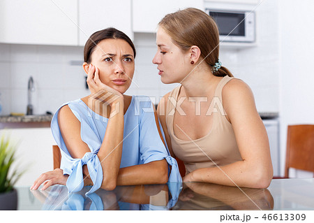 Girl telling her friend bad news Girl telling her friend bad news 46613309